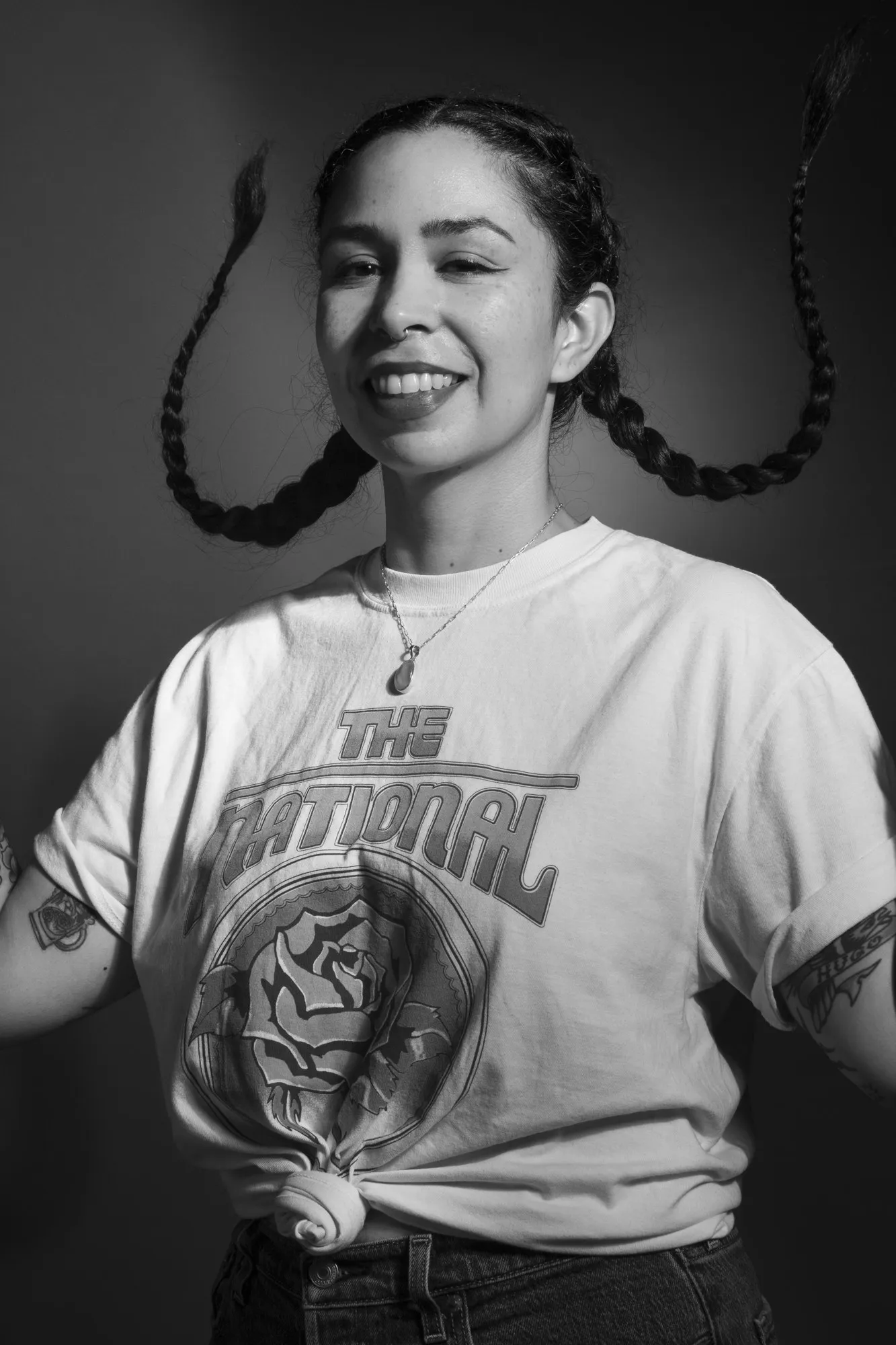 Black-and-white portrait of a smiling woman with her arms folded
