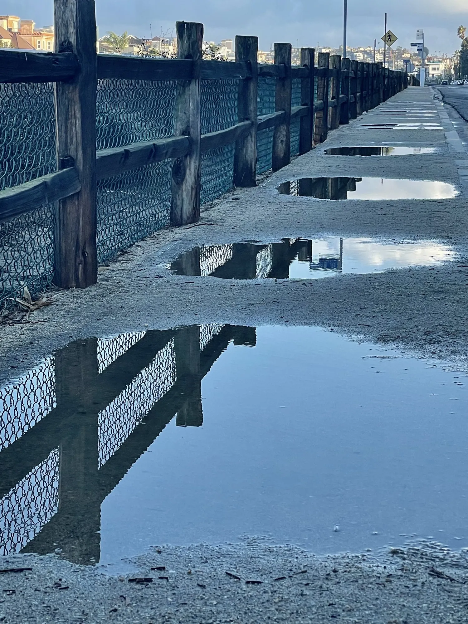 Repeating pier supports and blue shadows reflected in shallow water
