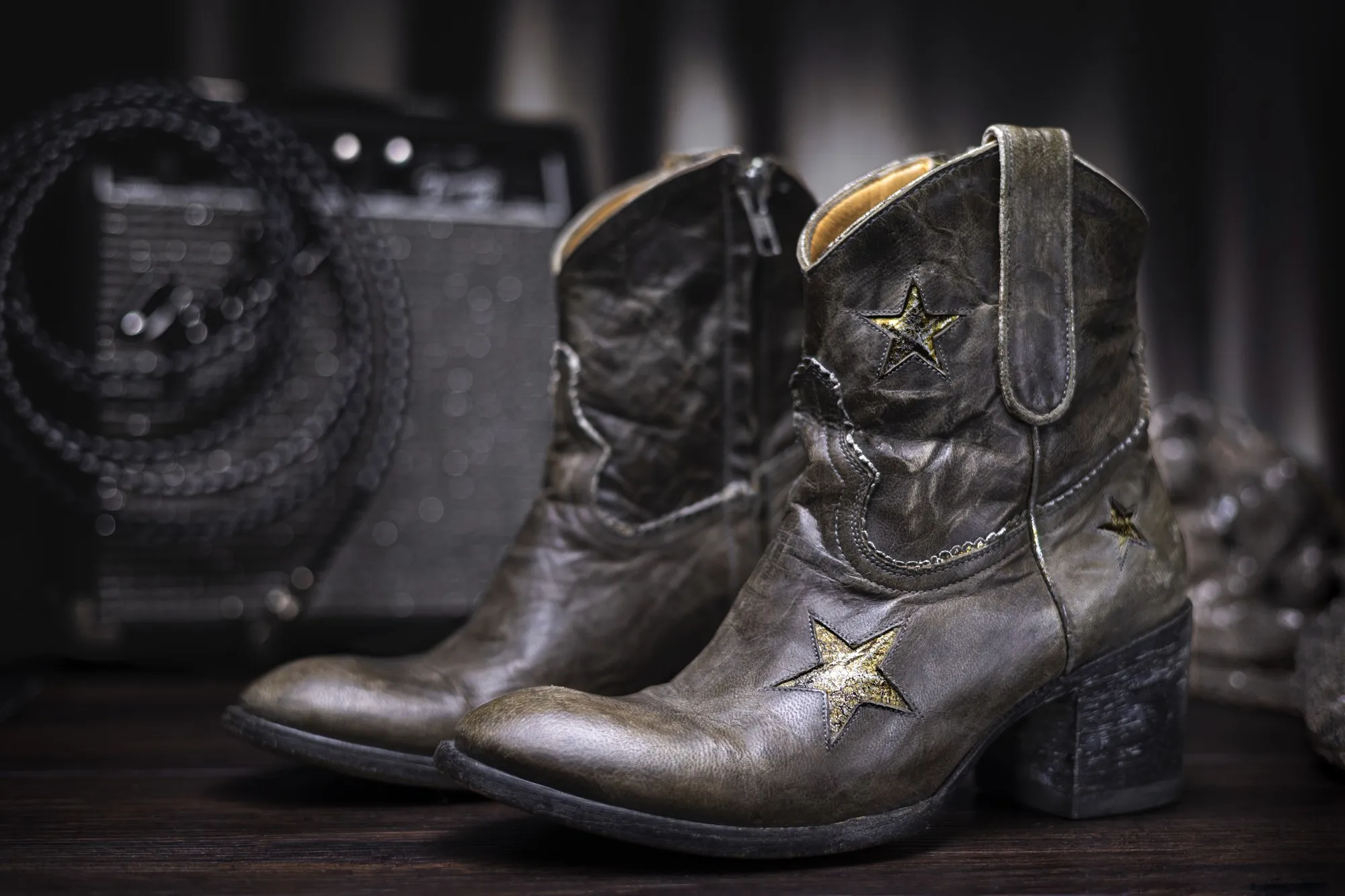 Worn leather boots on a textured surface